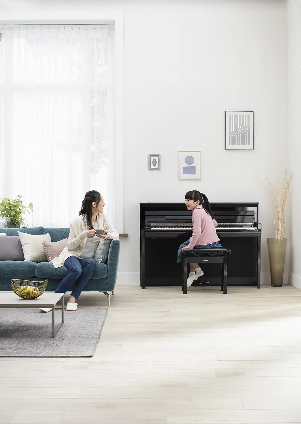 mother and daughter playing piano