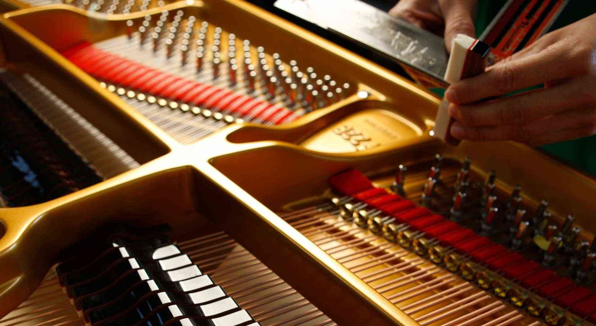 Professional grand piano tuning with precision tools in Calgary, AB